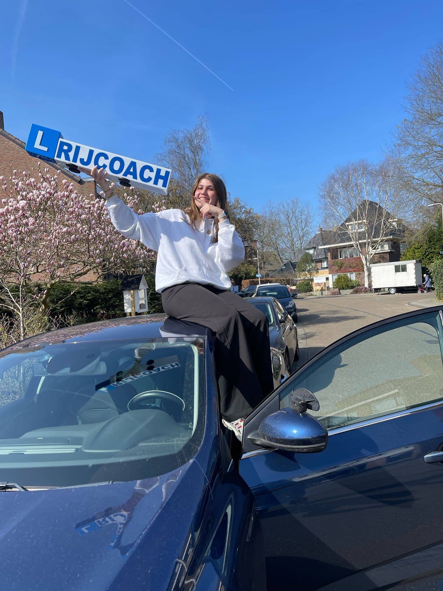 A Rijcoach student celebrating passing the driving test first time in Haarlem